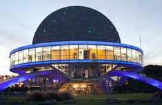 a large building with blue lights on it's sides