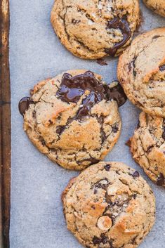 chocolate chip cookies with almonds on a baking sheet