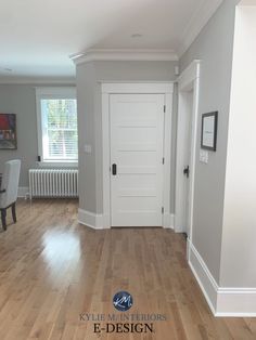 an empty room with hard wood flooring and white doors in the center is shown