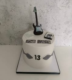 a birthday cake with a guitar on top