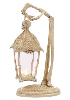 a wooden lantern with a candle in it on a white background and the light is lit up