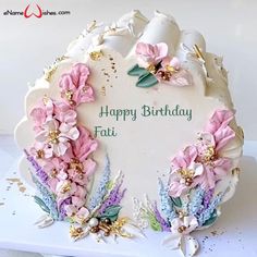 a birthday cake with flowers on it and the words happy birthday faith written in white frosting