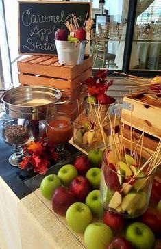 an assortment of apples and other fruits on a table