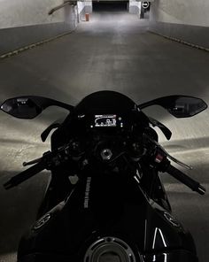 a motorcycle parked in a parking garage with no one on it's back end