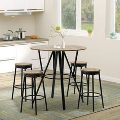 a kitchen table with four stools in front of it