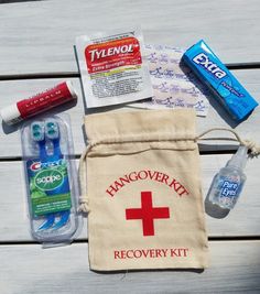 the contents of a personal emergency kit laid out on a wooden table, including toothpaste and mouthwash