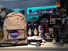 a nasa backpack sitting on top of a counter next to other items in a room