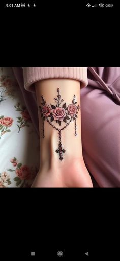 a woman's foot with tattoos on it, and roses in the cross tattoo