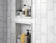 two shelves with soap, shampoo and other bathroom items