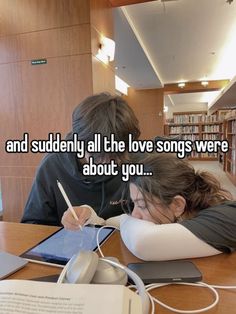 two people sitting at a table with an electronic device in front of them and the caption reads, and studying all the love songs were about you