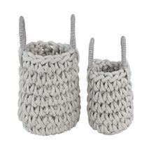 two knitted baskets sitting side by side on top of each other, one is gray and the other is white