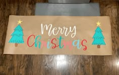 a merry christmas sign is on the floor