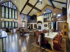 a large living room with high ceilings and wooden floors