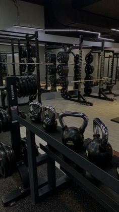 a gym filled with black kettles and exercise mats on top of eachother