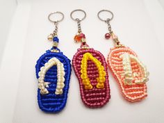 three beaded keychains with the word mcdonald written on them in different colors