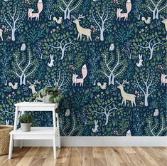 a wallpapered room with deer and trees in blue, pink and green colors