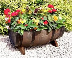 a large wooden barrel filled with lots of flowers