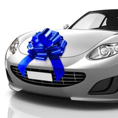 a silver sports car with a blue bow on the hood