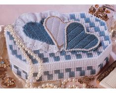 a blue and white box sitting on top of a table next to other jewelry items