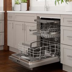 an open dishwasher in a kitchen