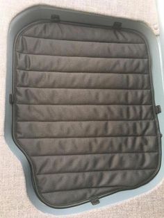 the inside of a car seat cover with zippers on it's back end