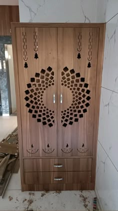 a wooden cabinet with intricate carvings on the doors