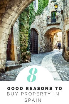 an alley way with the words 8 good reason to buy property in spain