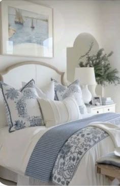 a bed with blue and white comforters in a bedroom