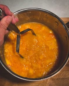 a person is stirring some food in a pot