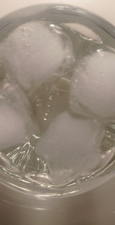 some ice cubes are in a glass with water