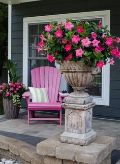 a pink chair sitting in front of a flower pot