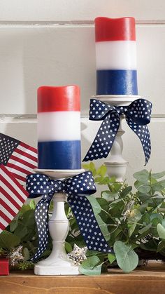 two patriotic candles are sitting on a table