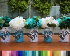 four mason jars with flowers in them are sitting on a table, and there is color swatches behind the jars