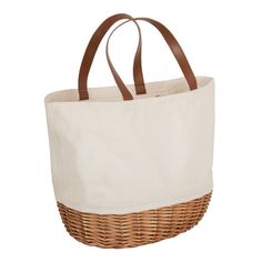 a large white bag with brown handles on a white background and wicker basket in the front