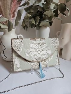 Green evening handbag wedding clutch shoulder bag designer clutch handbag pastel green clutch light green wedding clutch. Our Daardart clutch is the combination of chic style, originality and uniqueness. It is the ideal choice to add a touch of elegance and sophistication to your evening or wedding outfits. Made from carefully selected upholstery fabric scraps, each pouch is one of a kind. The satin lining adds a touch of comfort and elegance, while the snap closure helps keep your belongings secure. The clutch can be carried in the hand, under the arm or across the body and is suitable for an evening with friends as well as a more formal occasion. This gold pouch measures approximately 26 centimeters long and 16 centimeters wide. It is also possible to order a 120 cm long chain, gold or s Light Green Wedding, Light Green Fabric, Green Clutch, Green Clutches, Gifts For Your Sister, Prom Ideas, Wedding Clutch, Designer Clutch, Evening Handbag