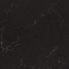 a black marble textured surface with white streaks on it's edges and dark colors