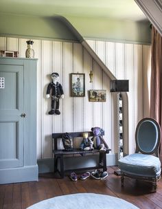 a room with a chair, mirror and other items on the wall next to it