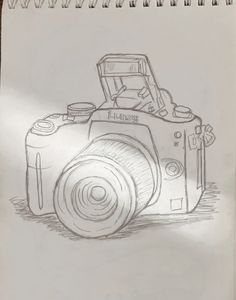 a drawing of a camera sitting on top of a piece of paper