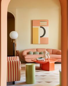 a living room filled with lots of furniture next to a painting on the wall over a coffee table