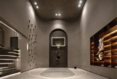 an indoor basketball court is shown in this modern home