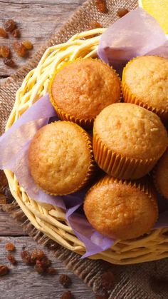 a basket filled with muffins sitting on top of a table