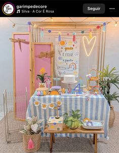 a table with a cake and decorations on it in front of a pink screen door