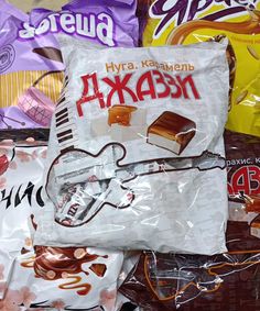 many different types of candy in bags on the ground