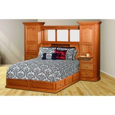 a bedroom with a bed, dressers and drawers in it's center area