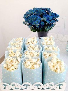 a table with popcorn bags and blue flowers on it