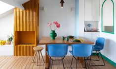 a dining room table with blue chairs next to it