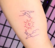 a tattoo on the arm of a woman with two hands holding each other's fingers