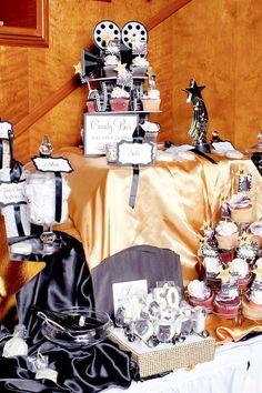 a table topped with lots of cupcakes and cakes