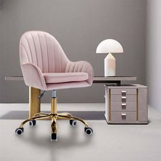 a pink chair sitting next to a desk with a lamp on it