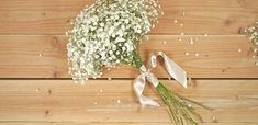 a bouquet of baby's breath on a wooden surface